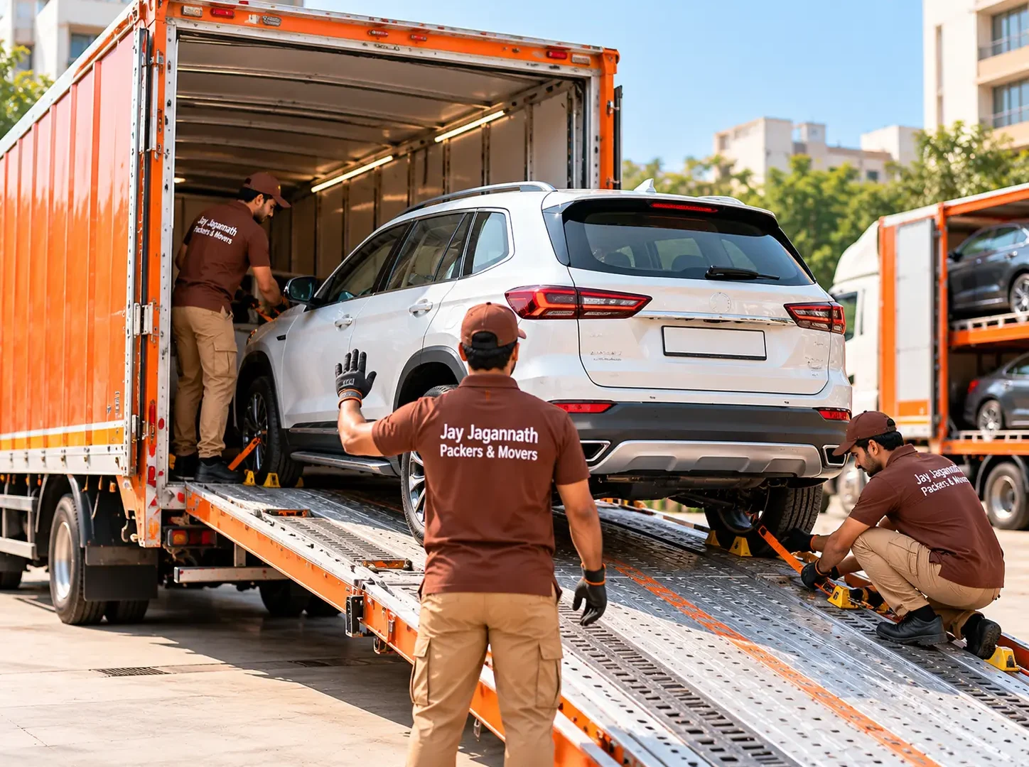 Car transport: a car being loaded up a ramp into an enclosed car carrier truck