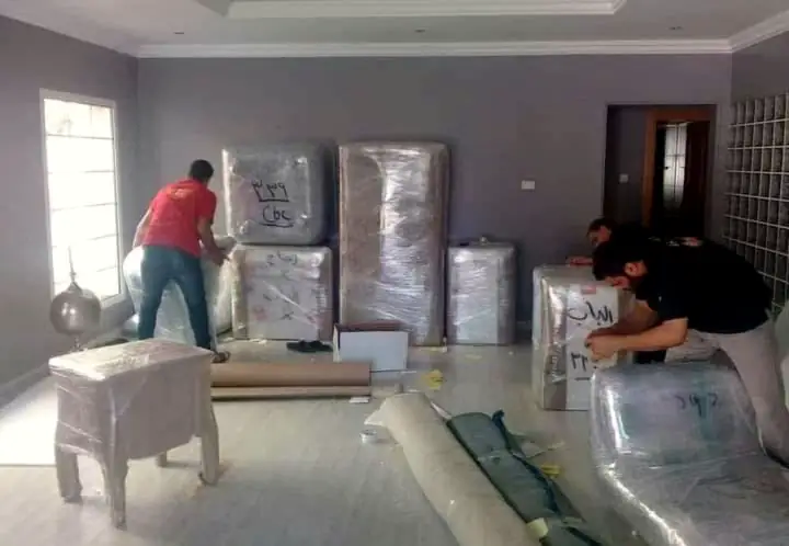 Packers wrapping furniture inside a home