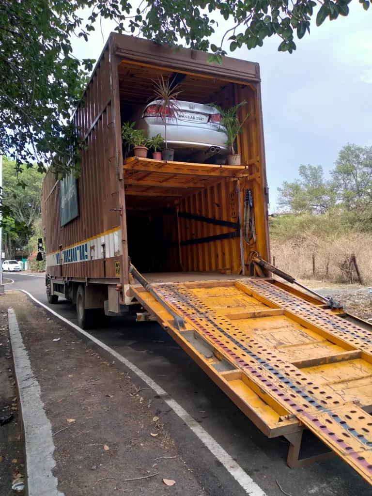 Car carrier truck with a car on the upper deck